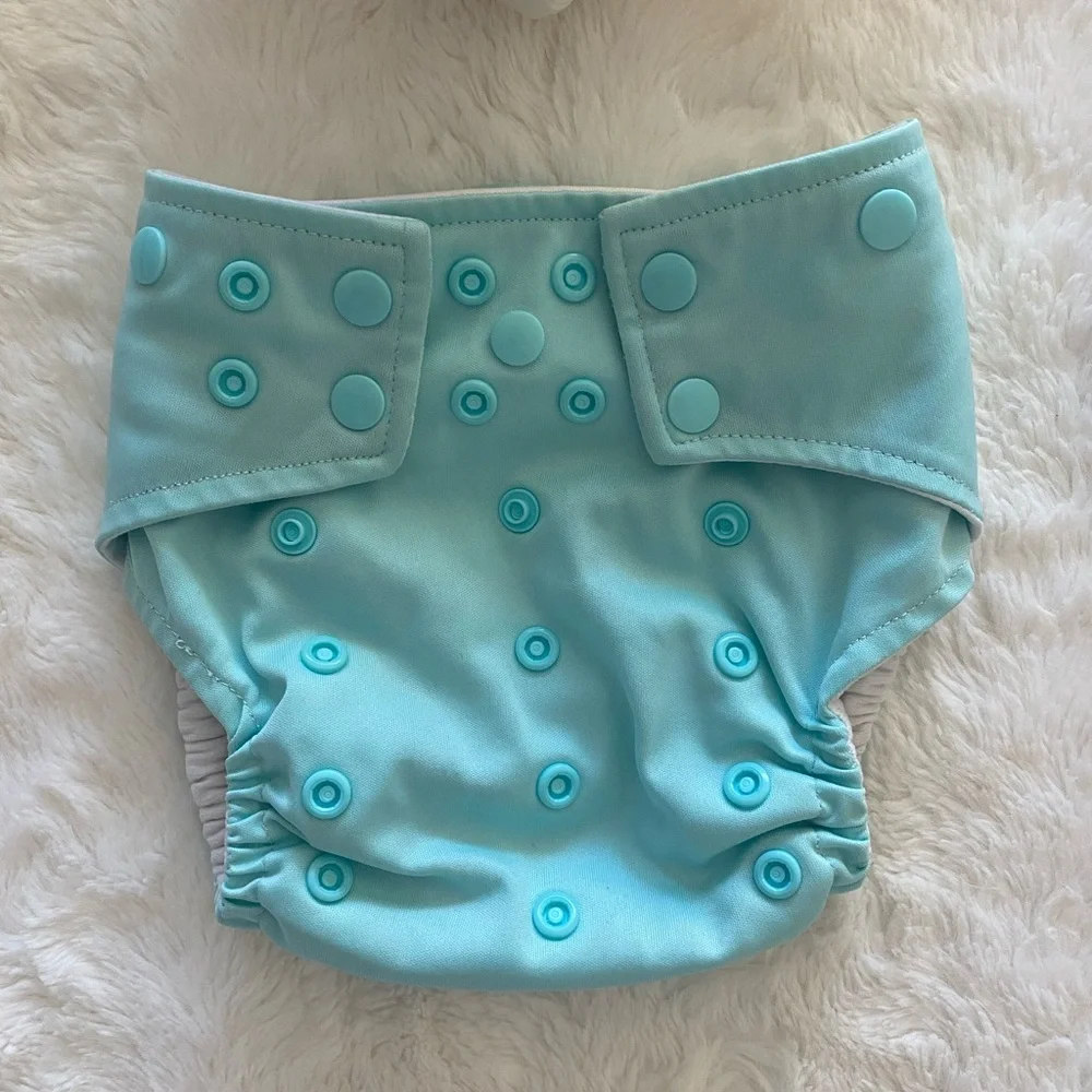 17 pocket cloth diapers + inserts, liners, and storage bags